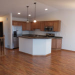 wood floors, kitchen island, railing, dining area, kitchen inside twin home
