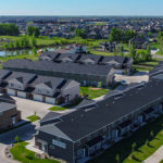 drone view of townhomes, shadow wood townhomes, west fargo townhomes, green grass, pond